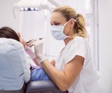 dentist-examining-female-patient