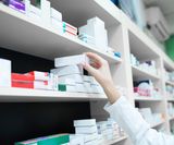 closeup-view-pharmacist-hand-taking-medicine-box-from-shelf-drug-store