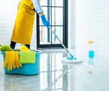 happy-young-woman-blue-rubber-using-mop-while-cleaning-floor-home